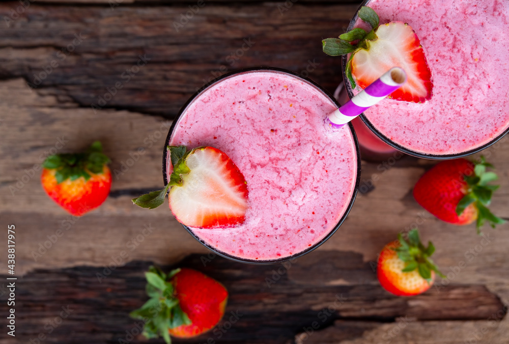 Strawberry mix banana smoothies juice beverage healthy the taste yummy In glass drink episode morning on wooden background from the top view. Strawberry mix banana smoothies juice beverage healthy the taste yummy In glass drink episode morning on wooden background from the top view.
