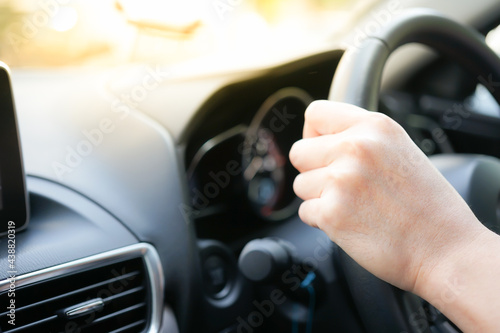 Close up of the hands of a man driver driving a luxury car chauffeur car driver service car sharing Taxi driver home delivery background concept © BLUEBOEING