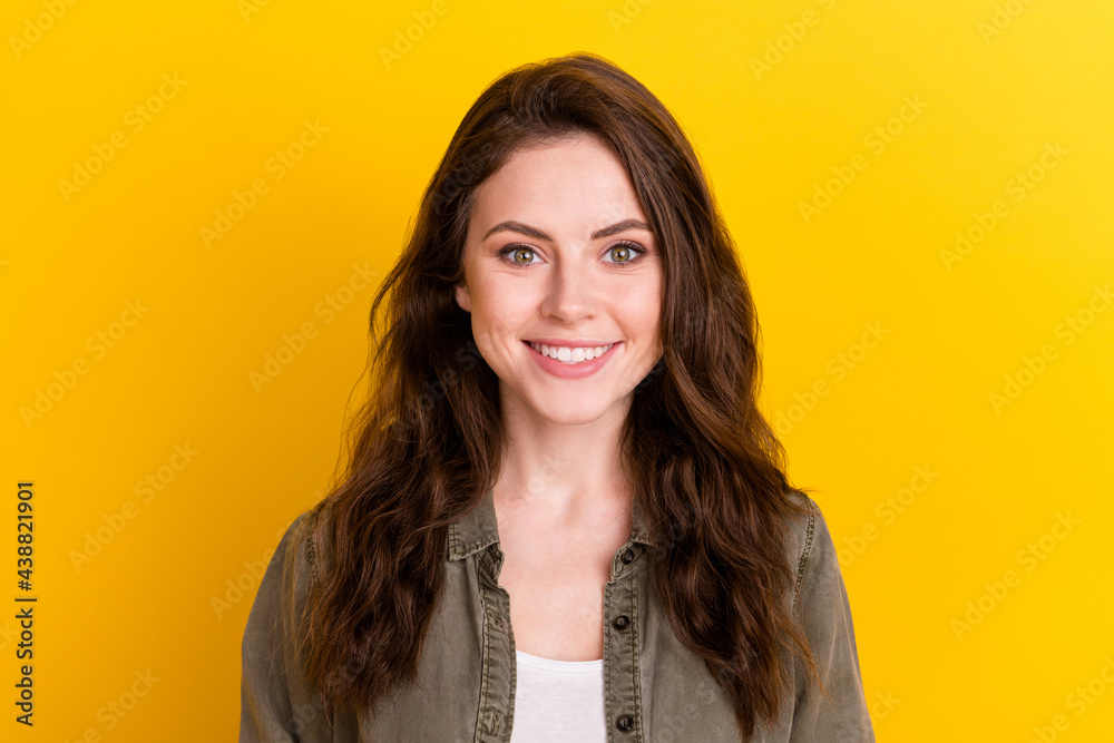 Photo of gorgeous satisfied lady beaming smile look camera isolated on bright yellow color background Photo of gorgeous satisfied lady beaming smile look camera isolated on bright yellow color background