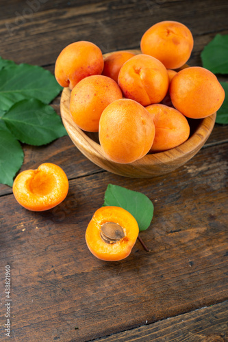 Delicious ripe apricots in a wooden bowl