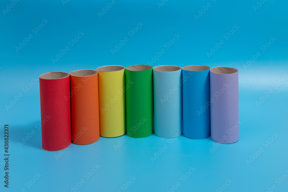 simple activity for kids, toilet paper roll craft, colorful tubes on blue background simple activity for kids, toilet paper roll craft, colorful tubes on blue background