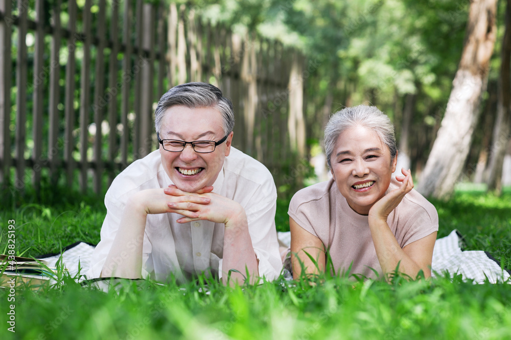 Happy old couple looking at the scenery in the park Happy old couple looking at the scenery in the park