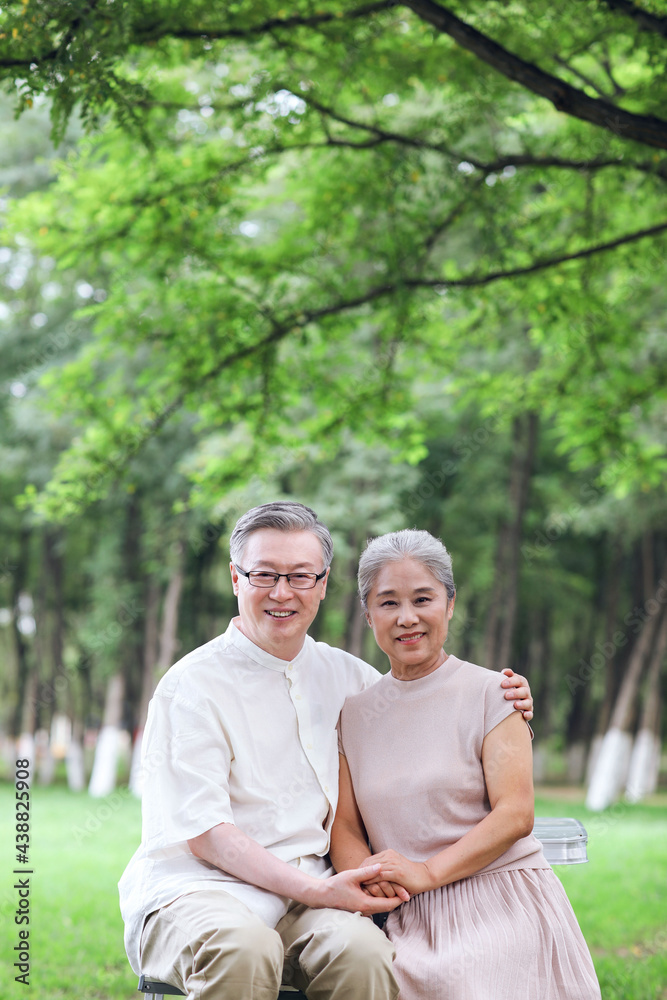 Happy old couple sitting on chairs in outdoor park Happy old couple sitting on chairs in outdoor park