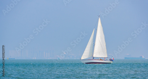 Sailboat sailing on the ocean between Breskens and vlissingen, recreational summer sports, Zeeland, The Netherlands © Charlotte B