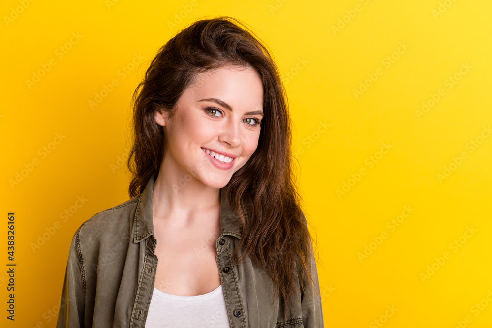 Portrait of gorgeous young lady beaming smile look camera isolate don bright yellow color background Portrait of gorgeous young lady beaming smile look camera isolate don bright yellow color background