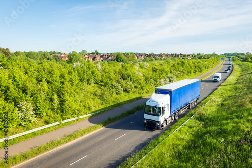 uk motorway road traffic over new build town development in england