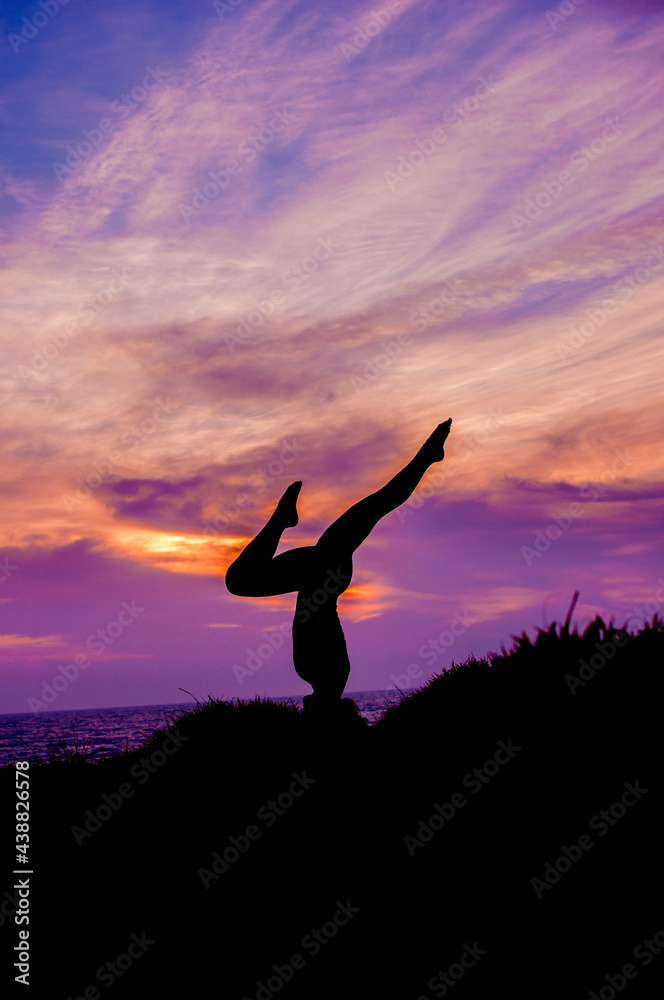 silhouette of a woman doing yoga