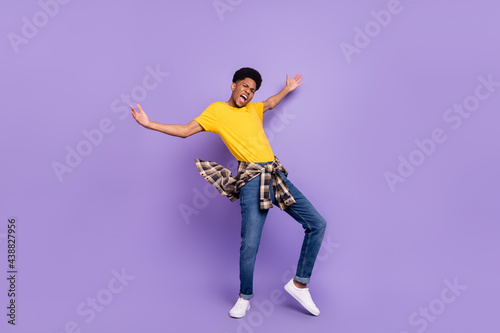 Full length body size view of attractive cheerful crazy guy dancing having fun good mood rest isolated over violet purple color background