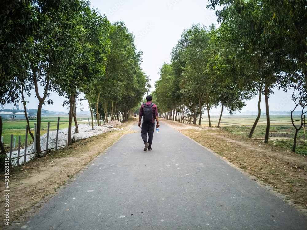 Traveler walking into the horizon on the Ring Road enjoying the scenery Traveler walking into the horizon on the Ring Road enjoying the scenery