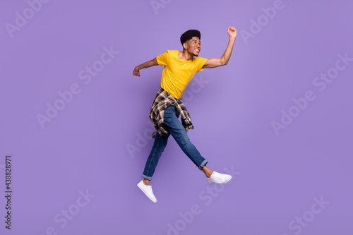 Full length body size view of attractive cheerful glad guy jumping walking good mood isolated over violet purple color background