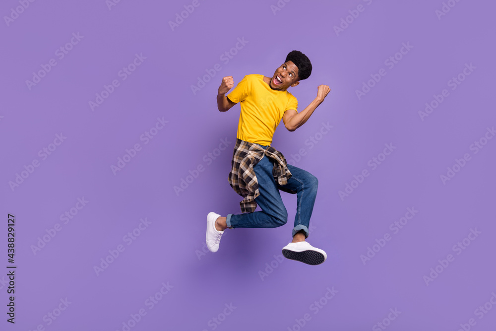 Full length body size view of attractive cheerful successful guy jumping celebrating isolated over violet purple color background