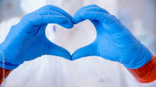 Nurse coronavirus with medical mask and blue glove hands shows symbol of love heart. Concept safety support our med doctor professions