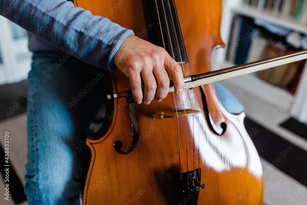 Detail of man touching the cello Detail of man touching the cello