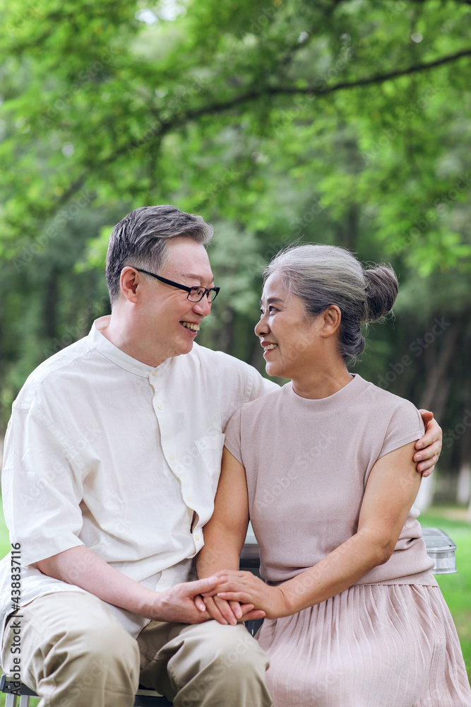 Happy old couple sitting on chairs in outdoor park Happy old couple sitting on chairs in outdoor park