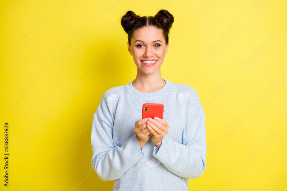 Portrait of attractive cheerful girl using device chatting comment share feedback isolated over vibrant yellow color background Portrait of attractive cheerful girl using device chatting comment share feedback isolated over vibrant yellow color background
