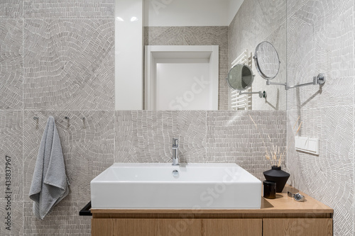 Stylish washbasin in bathroom with modern  patterned tiles