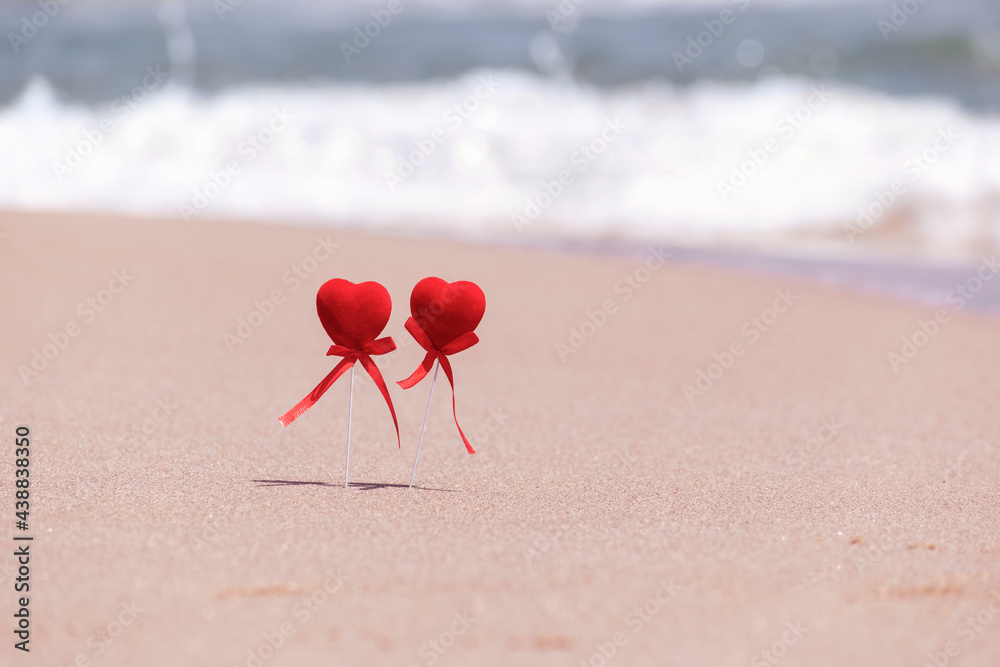 Couple of lovers run on sandy beach against background of sea waves. Creative idea of love, healthy lifestyle, active recreation, sport in nature, well-being, travel and summer holidays. Copy space Couple of lovers run on sandy beach against background of sea waves. Creative idea of love, healthy lifestyle, active recreation, sport in nature, well-being, travel and summer holidays. Copy space