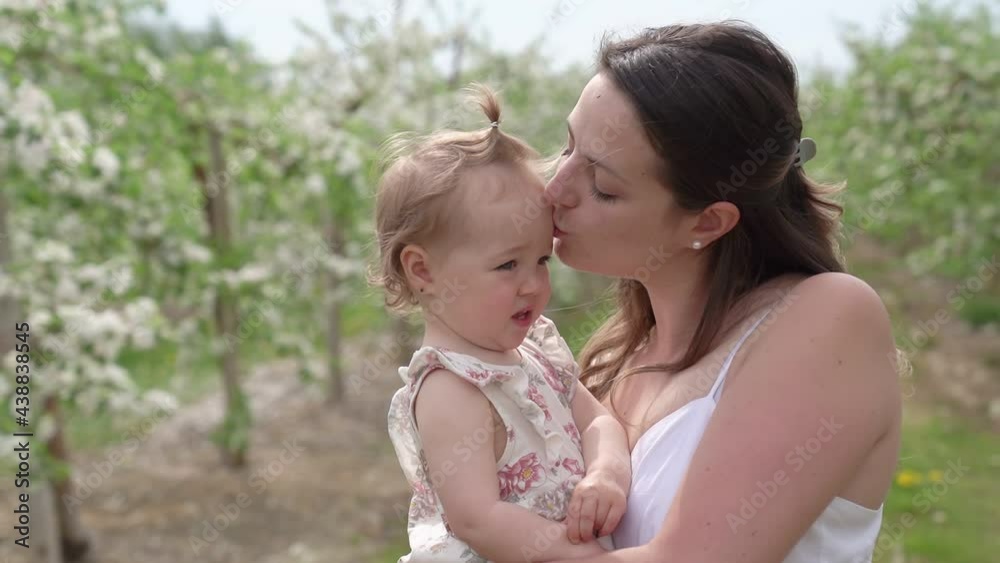 portrait of mother and baby girl outdoors in apple tree flower portrait of mother and baby girl outdoors in apple tree flower