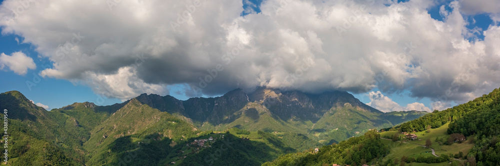 Panorama view to the Seriana valley and Orobie Alps with big cloud and blue sky
