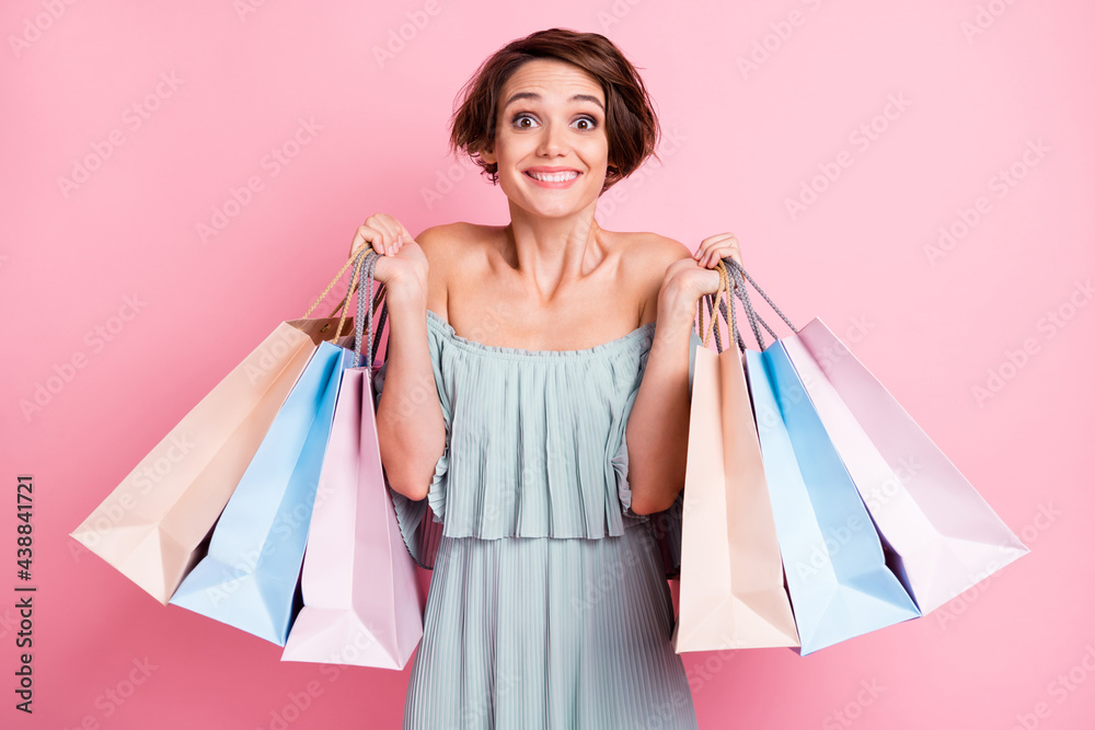 Photo of young cheerful girl happy positive smile hold shopping bags buy purchase sale isolated over pink color background