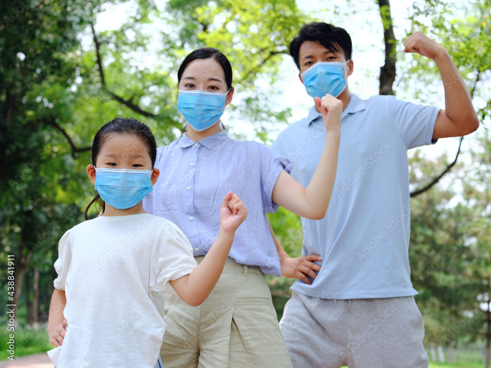 A young family of three with masks A young family of three with masks