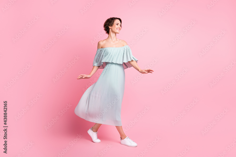 Full length profile side photo of young girl happy positive smile go walk look empty space isolated over pastel color background Full length profile side photo of young girl happy positive smile go walk look empty space isolated over pastel color background