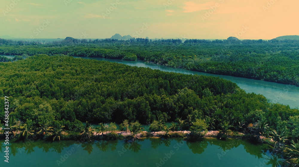 Obraz premium AERIAL. Top film style view of traditional thai boat and river with mountain on the backrgound.