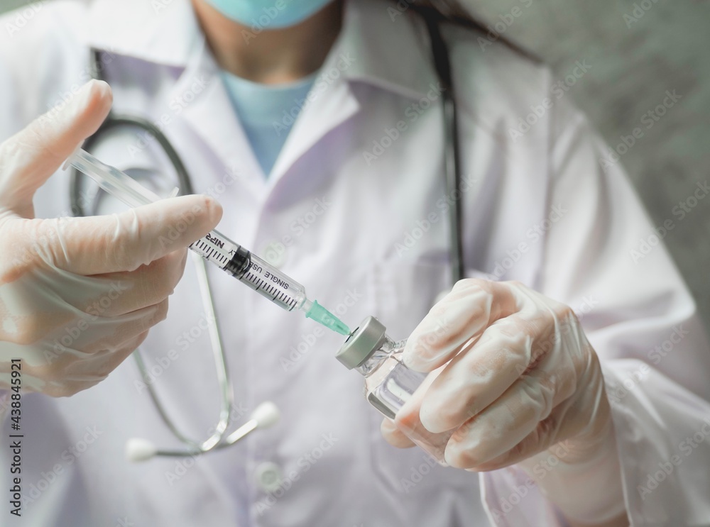 Doctor filling syringe with medication, Vaccination and immunization. Concept fight against virus covid-19 corona. medical care,science. Doctor filling syringe with medication, Vaccination and immunization. Concept fight against virus covid-19 corona. medical care,science.