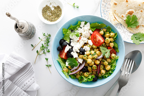 Mediterranean Greek and chickpea salad with fresh vegetables and feta cheese, top view photo