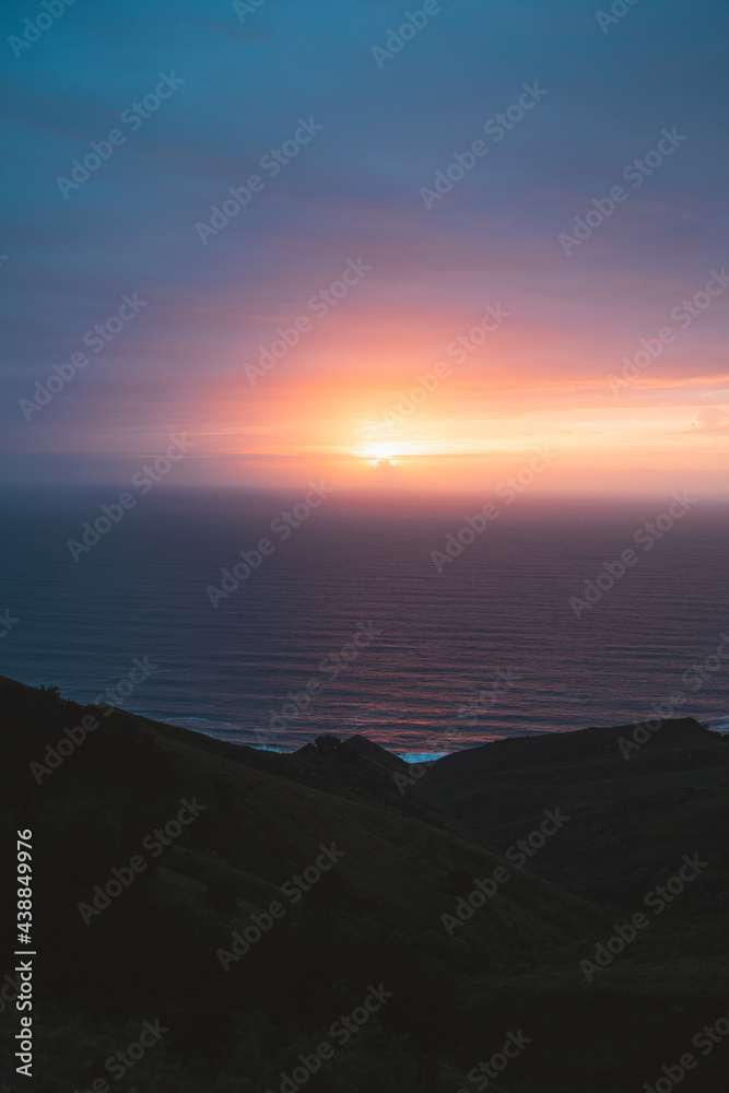 Sun setting on the atlantic ocean from the top of Jaizkibel hills