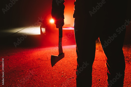 Photography maniac killer near the car at night close-up