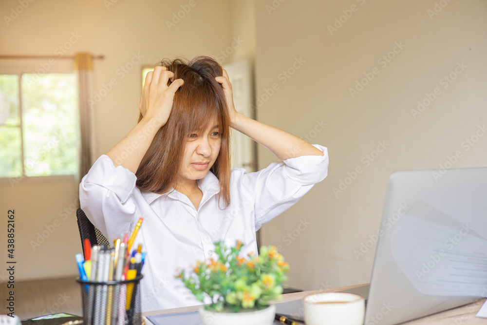 stressed woman from working hard at home and she is biting the paper, home office business concept. stressed woman from working hard at home and she is biting the paper, home office business concept.