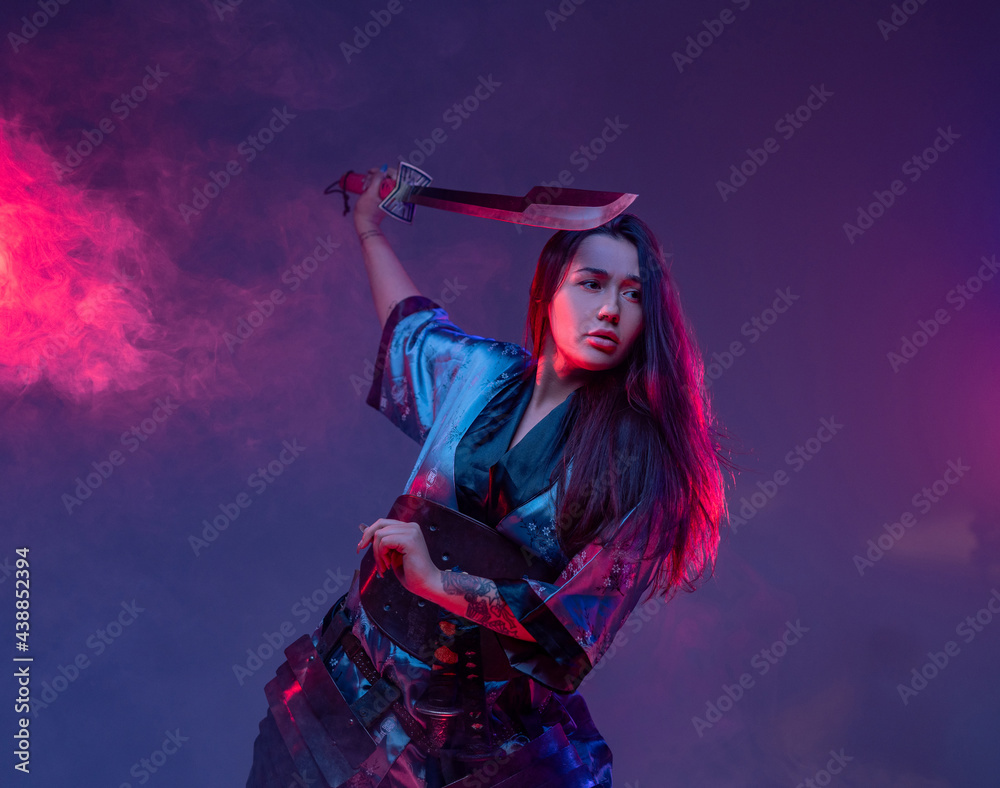 Eastern woman with samurai sword in fight stance