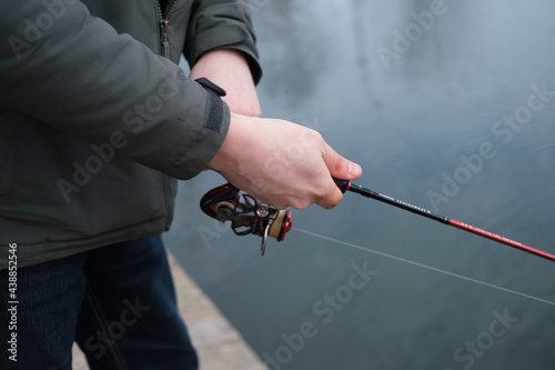 Fishing. A man holding a fishing rod in his hands