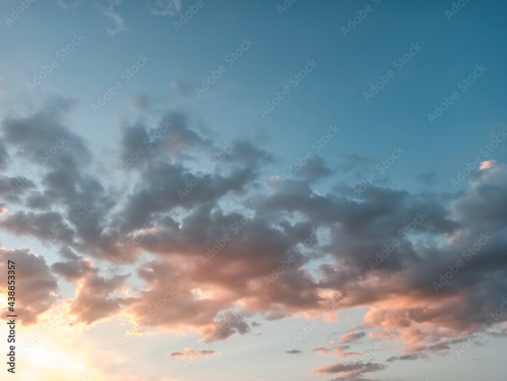 Fototapeta premium the background of the sunset blue sky with orange pink clouds. beautiful sky landscape.
