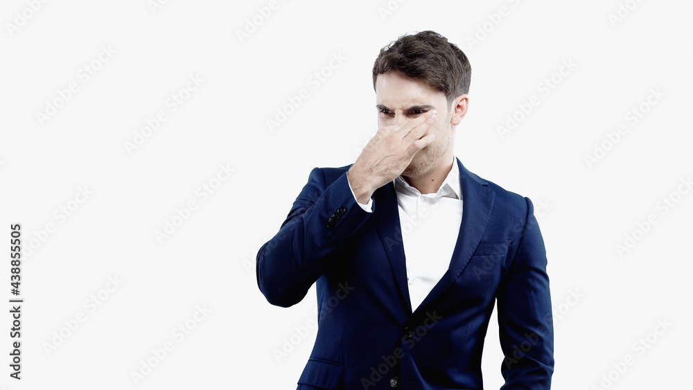 Disgusted businessman covering nose isolated on white Disgusted businessman covering nose isolated on white