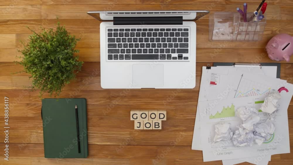 Phrase is a good job done by hands from wooden cubes on the desktop. On table put cubes with the words good work. Phrase is a good job done by hands from wooden cubes on the desktop. On table put cubes with the words good work.