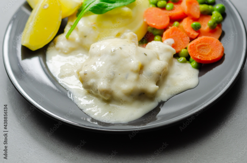 Cod Mornay, flaky cod with a creamy cheese sauce, with mashed potato, peas and carrots Cod Mornay, flaky cod with a creamy cheese sauce, with mashed potato, peas and carrots