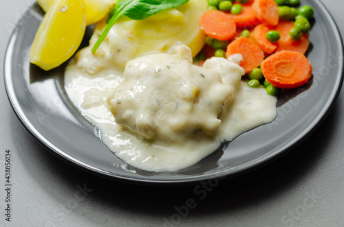 Cod Mornay, flaky cod with a creamy cheese sauce, with mashed potato, peas and carrots