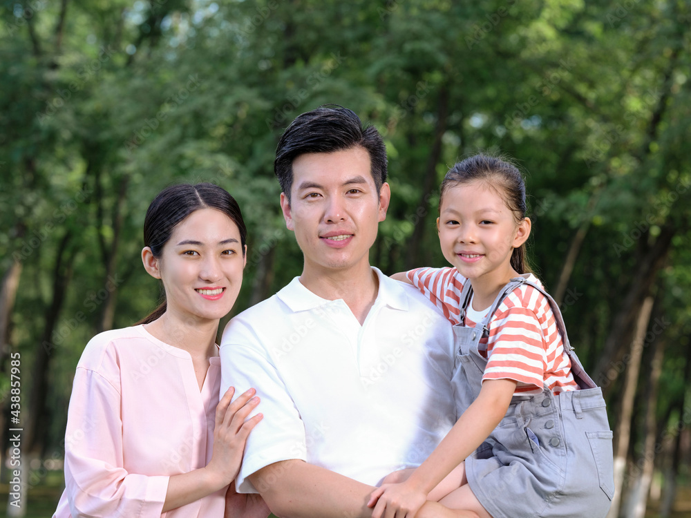 Happy family of three playing in the park Happy family of three playing in the park