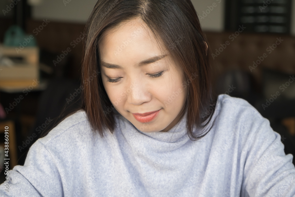 Young adult beautiful black hair Asian woman happy on work while closing the eyes and smile to feel good and relax with success in the work modern office Young adult beautiful black hair Asian woman happy on work while closing the eyes and smile to feel good and relax with success in the work modern office