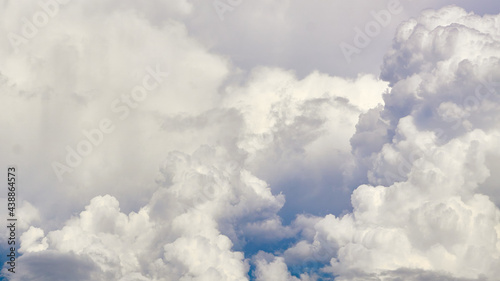 White porous clouds on the blue sky, cloudy landscape.