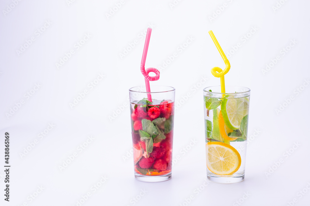 Cocktails isolated on white background. Lemon and lime, mint and raspberries cocktails. Cocktails isolated on white background. Lemon and lime, mint and raspberries cocktails.