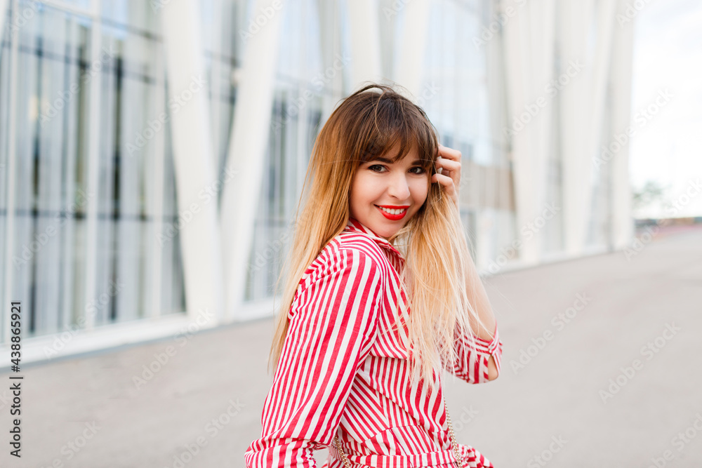 Close up portrait of Happy woman in red dress posing on the street. Close up portrait of Happy woman in red dress posing on the street.