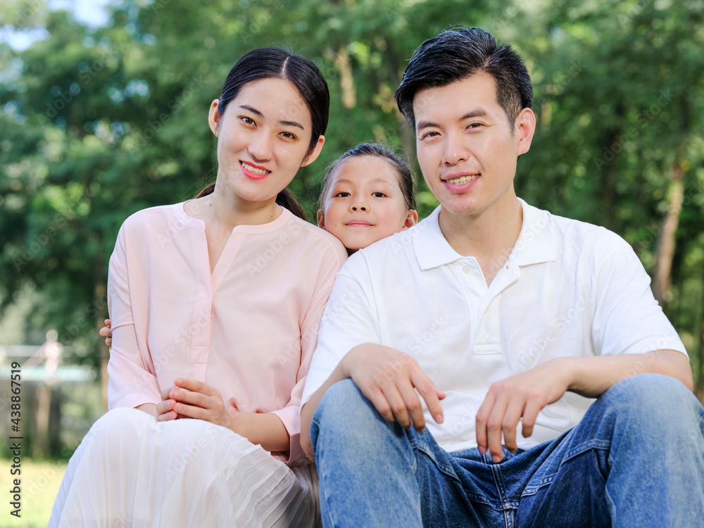 Happy family of three playing in the park Happy family of three playing in the park