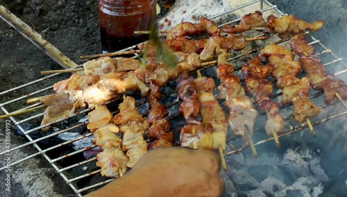 Pork sticks roasted on a coal grill