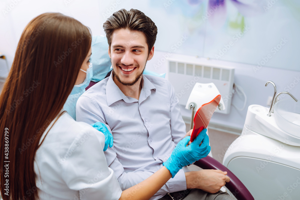Dentist woman examining a patient's teeth in the dentistry. Overview of dental caries prevention. Healthy teeth and medicine concept. Dentist woman examining a patient's teeth in the dentistry. Overview of dental caries prevention. Healthy teeth and medicine concept.
