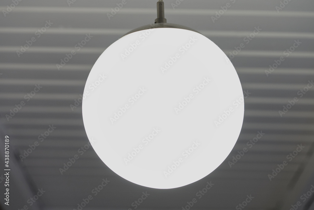 Beautiful and stylish lamp in the form of a hanging ball on the wooden ceiling in the kitchen. modern design Beautiful and stylish lamp in the form of a hanging ball on the wooden ceiling in the kitchen. modern design