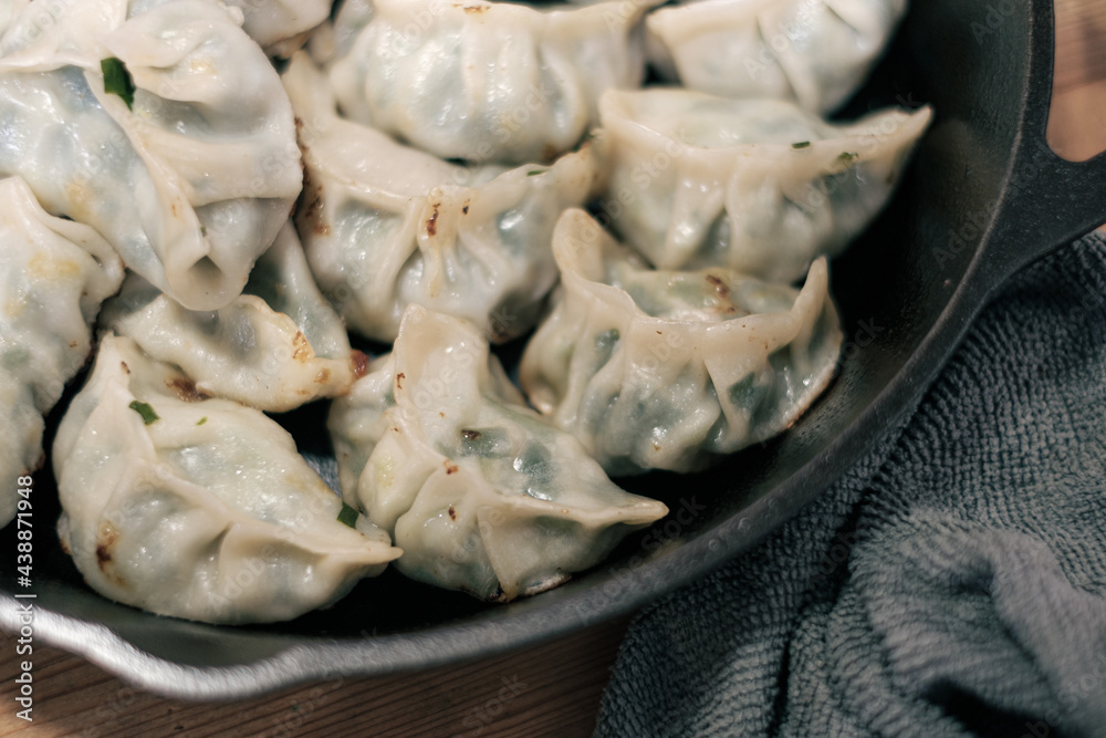 Homemade Chinese Dumplings fried in a cast iron skillet. Homemade Chinese Dumplings fried in a cast iron skillet.