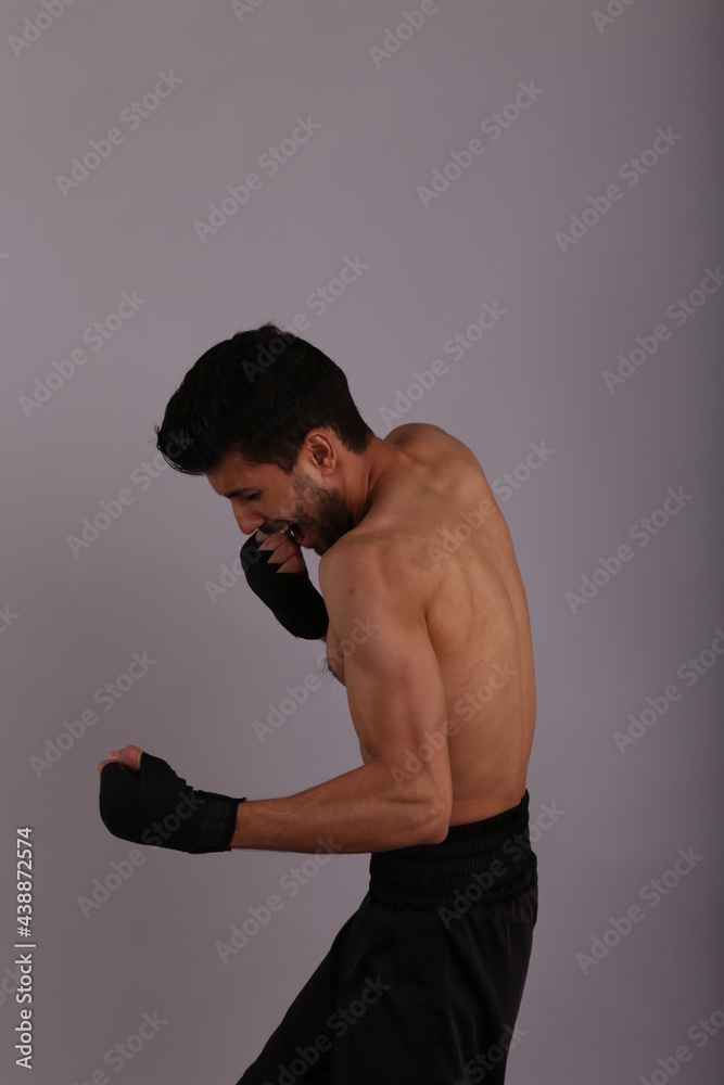 Portrait of a fighter on grey background Portrait of a fighter on grey background